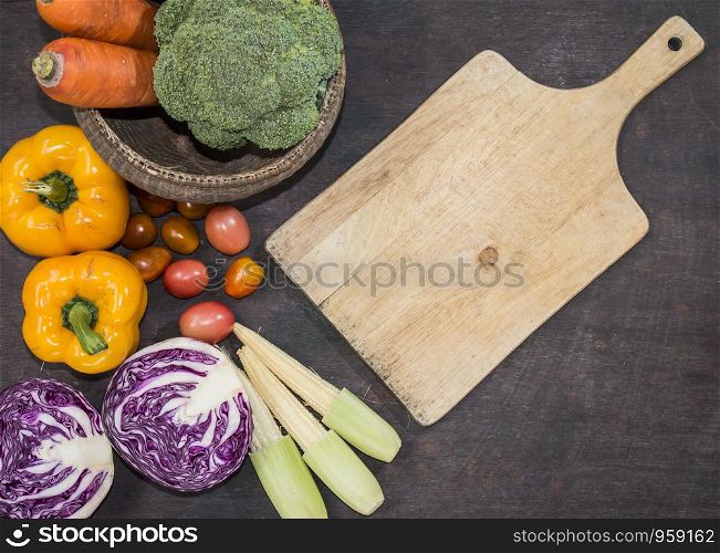 Various vegetables with cutting board on wooden background,top view,food background,healthy concept