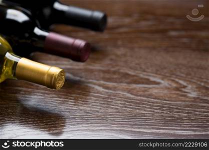 Various Wine Bottles on a Reflective Wood Surface Abstract.