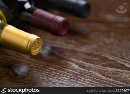 Various Wine Bottles on a Reflective Wood Surface Abstract.