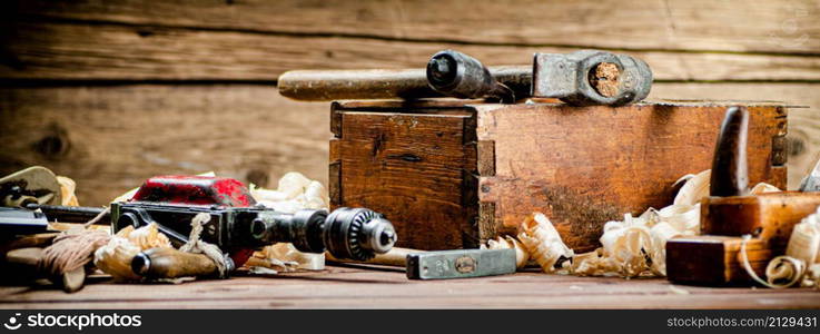 Various working tools on wood on the table. On a wooden background. High quality photo. Various working tools on wood on the table.