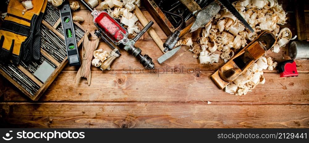 Various working tools on wood on the table. On a wooden background. High quality photo. Various working tools on wood on the table.