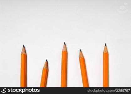 Various yellow pencils on white.