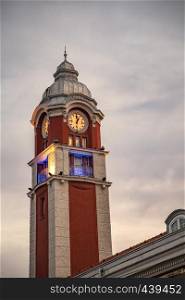 Varna, Bulgaria. Railway station clock tower. Tower is red, decorative details and a dome are white. The station building was opened in 1925.
