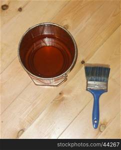varnish brush with tin can on wooden floor