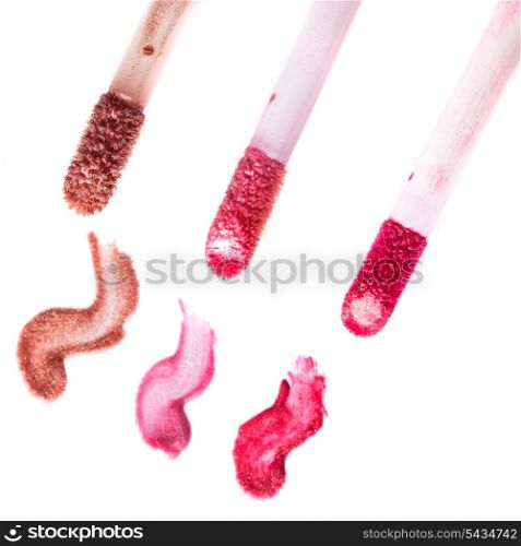 Varuous smears of lip gloss on white background