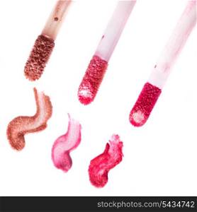 Varuous smears of lip gloss on white background