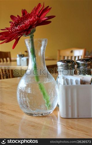 Vase on table with flower in restaurant