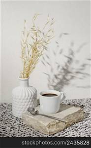 vase with dry wheat cup coffee
