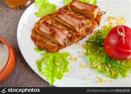 veal meat with bacon. roast of veal meat with bacon with potatoes