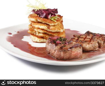 Veal Medallions with potato pancakes. Closeup.