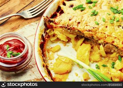 Veal, potato and cheese casserole. Meat gratin with potatoes and cheese. French meat, a popular dish for the festive table.