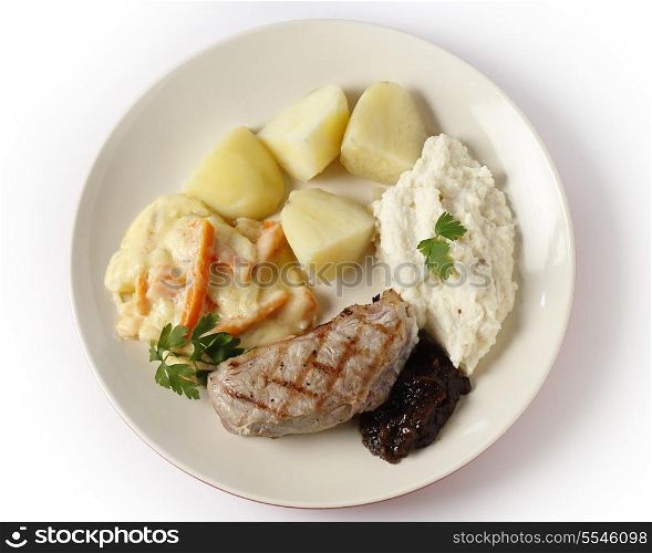 Veal sirloin steak with onion marmalade, celeriac puree, julienned carrots in a white sauce and boiled potatoes, garnished with parsley.