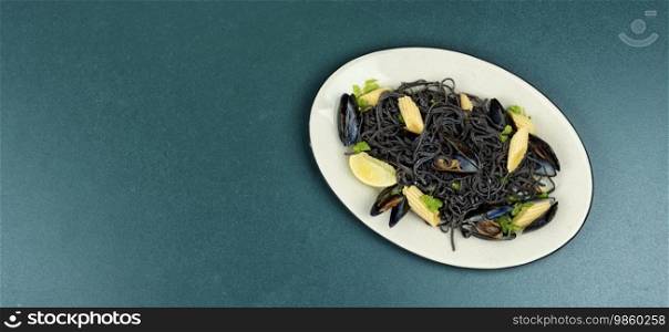 Vegan black bean pasta with mussels. Spaghetti with seafood. Pasta vongole. Space for text.. Black pasta with mussels and corn.