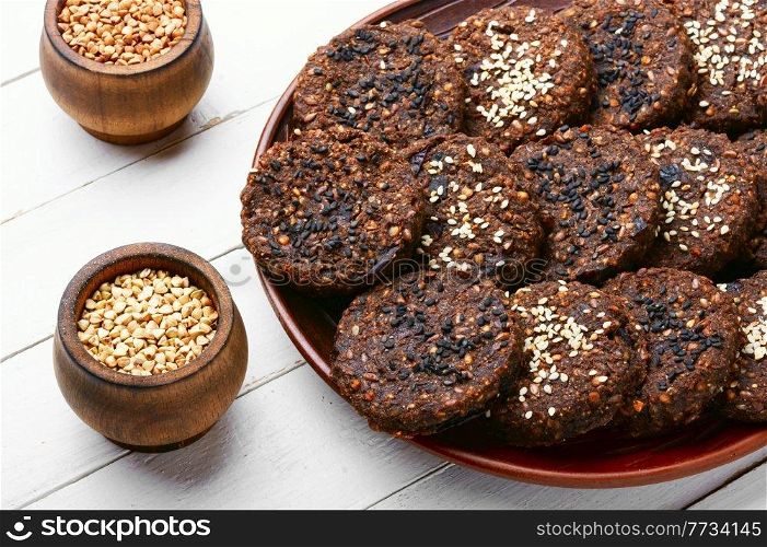 Vegan buckwheat pastry with sesame seeds on the plate. Vegetarian buckwheat cookies.