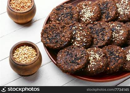 Vegan buckwheat pastry with sesame seeds on the plate. Vegetarian buckwheat cookies.