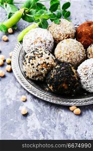 Vegan chocolate truffles. Vegan candy with chickpeas, raisins, dried apricots and nuts. Clean food