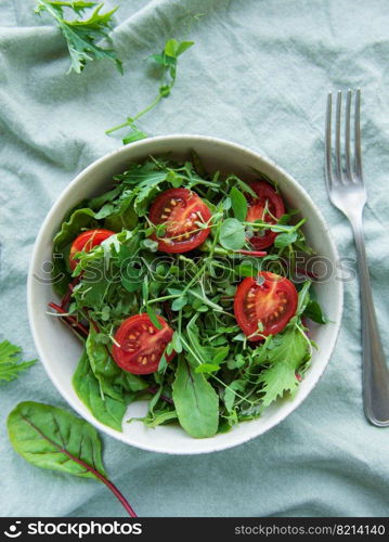 Vegan food: healthy fresh vegetables salad. Salad with arugula and cherry tomatoes. 