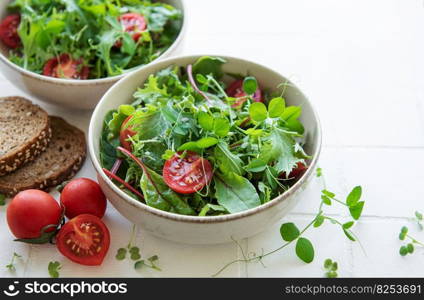 Vegan food  healthy fresh vegetables salad. Salad with arugula and cherry tomatoes. 