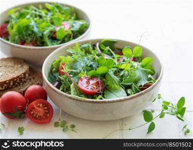 Vegan food  healthy fresh vegetables salad. Salad with arugula and cherry tomatoes. 