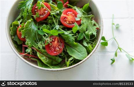 Vegan food: healthy fresh vegetables salad. Salad with arugula and cherry tomatoes. 