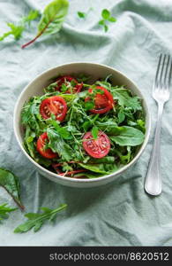 Vegan food: healthy fresh vegetables salad. Salad with arugula and cherry tomatoes. 