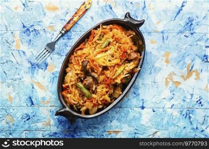 Vegan food, stewed cabbage with carrots and mushrooms. Homemade food, recipe place. Cabbage stewed with mushrooms.