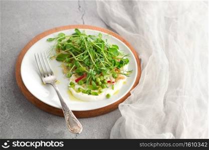 Vegan healthy salad made microgreen sprouts peas, quinoa, radish, mint and yogurt 