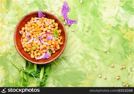 Vegan healthy salad with chickpeas and raisins. Bowl of vegan salad
