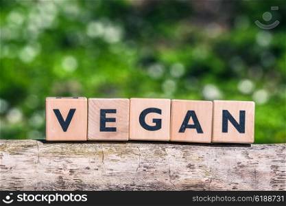 Vegan label on a tree log in a garden