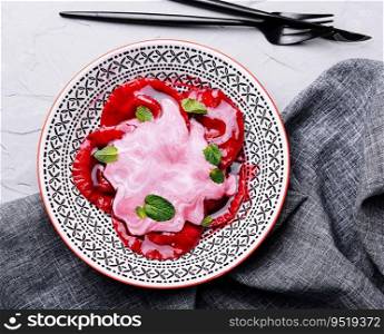 Vegan red ravioli with beetroot on a plate in cream sauce