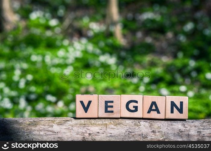 Vegan sign in a green garden in the spring