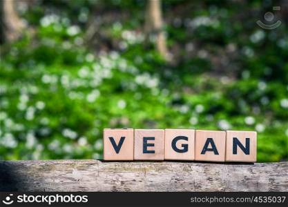 Vegan sign in a green garden in the spring