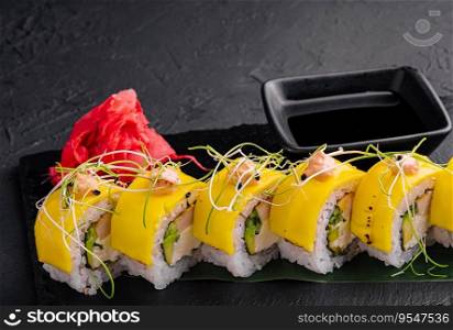 Vegan yellow maki sushi rolls on stone