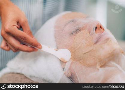 Vegetable Based Facial Hydration Mask. Cosmetologist applying beauty mask onto woman’s face. Face Hydrating Mask, Vegetable Based Facial Treatment in Beauty Salon.