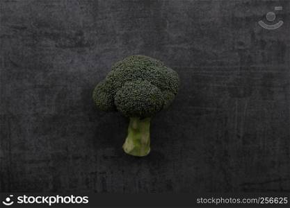 Vegetable broccoli isolated on dark rock background
