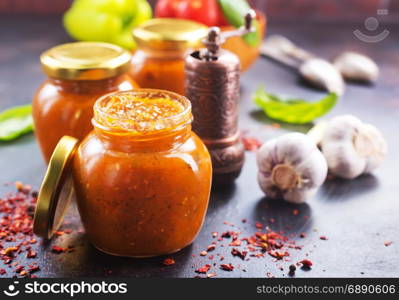 vegetable caviar in glass bank and on a table