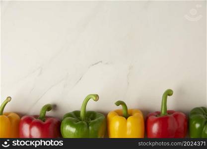 vegetable concept several of red, yellow, and red bell peppers being organized on the white background.