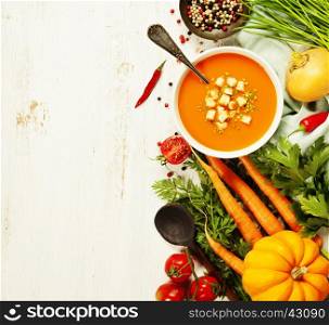 Vegetable cream soup on white rustic background