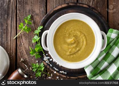 Vegetable cream soup, puree on wooden rustic table, top view
