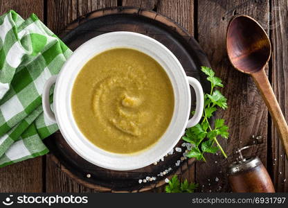 Vegetable cream soup, puree on wooden rustic table, top view