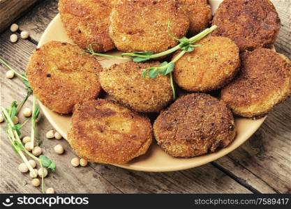 Vegetable diet cutlets made from green peas on wooden table.Healthy diet food. Diet cutlets from peas.