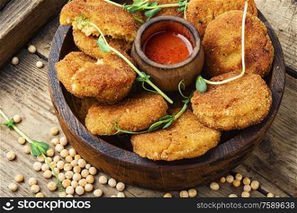 Vegetable diet cutlets made from green peas on wooden table.Vegetarian food. Diet cutlets from peas.