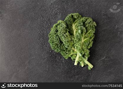 vegetable, food and culinary concept - close up of kale cabbage on slate stone background. close up of kale cabbage on slate background