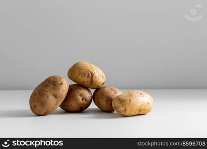 vegetable, food and culinary concept - close up of potatoes on table. close up of potatoes on table
