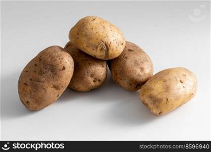 vegetable, food and culinary concept - close up of potatoes on table. close up of potatoes on table