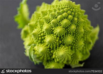 vegetable, food and culinary concept - close up of romanesco broccoli on table. close up of romanesco broccoli on table