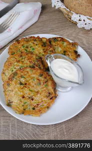 Vegetable fritters of zucchini with peas and herbs