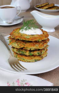 Vegetable fritters of zucchini with peas and herbs