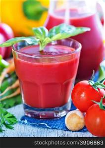 vegetable juice in glass and on a table