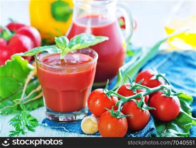 vegetable juice in glass and on a table